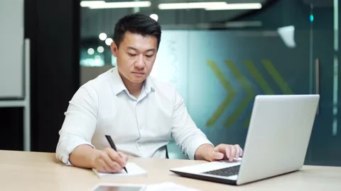 Focused businessman study online watching webinar. Asian business man employee  Stock Footage 218239440