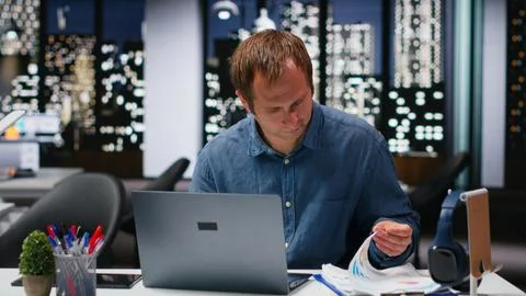 Focused businessman using computer to analyze insights and performance metrics Stock Photos