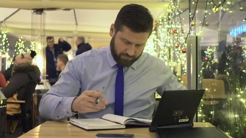 Focused businessman work with tablet, calendar, cafe, christmas, evening Vídeo Stock 73000704