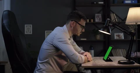 Focused businessman working on green screen digital tablet at home office Stock Footage 275554272