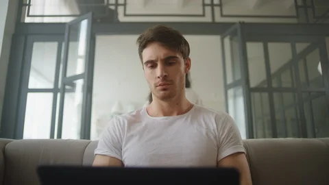 Focused businessman working laptop computer at home. Sexy man hugging woman 스톡 동영상 120009372