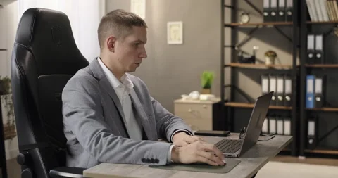 Focused businessman working on laptop looking at computer laptop screen at Stock-Footage 275960688