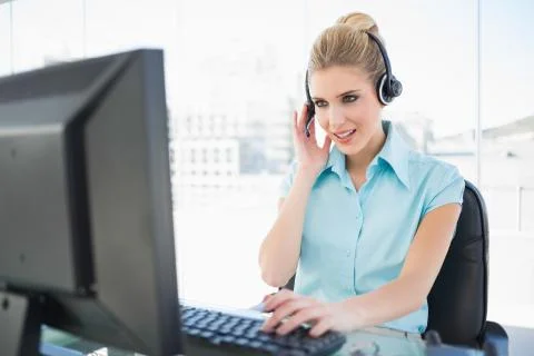 Focused call centre agent working on computer Stock Photos