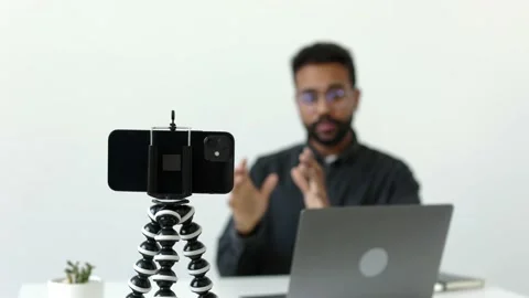 Focused camera tripod recording serious african american man talk to colleagues Stock Footage 196127079