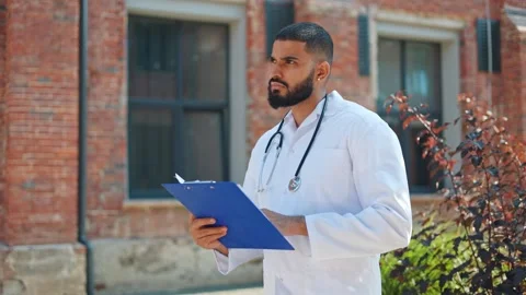 Focused cardiologist checking patient's results and thinking about treatment Stock Footage 250076214