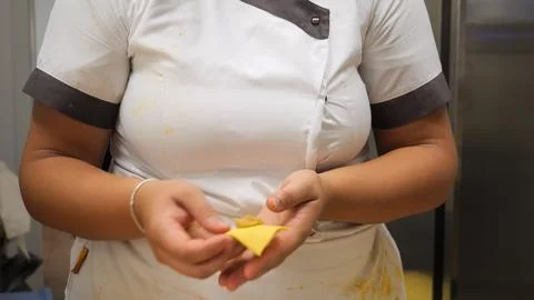 Focused chef meticulously crafts delicate tortellini pasta by hand in a bri.. Stock Photos