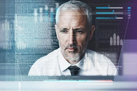 Focused on coding. a mature businessman working on programming code. Stock Photos