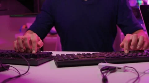 Focused coding session. Hands dash across keys with vibrant illumination Stock-Footage 347874557