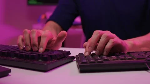 Focused coding session. Hands dash across keys with vibrant illumination Stock-Footage 347874579