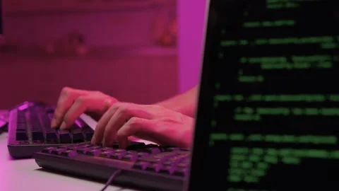 Focused coding session. Hands dash across keys with vibrant illumination Stock-Footage 347874598