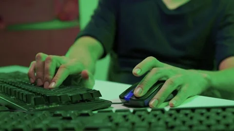 Focused coding session. Hands dash across keys with vibrant illumination Stock Footage 347874844