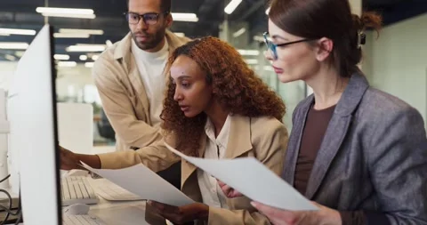 Focused colleagues analyzing data at computer in office meeting, planning Stock Footage 343793091
