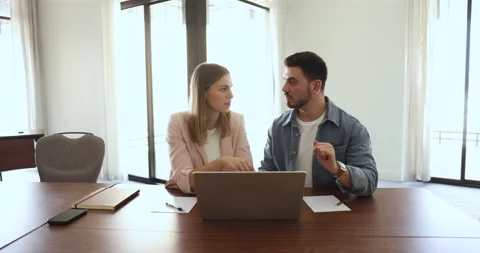 Focused colleagues cooperate, brainstorm using computer at office meeting Stock Footage 262907908