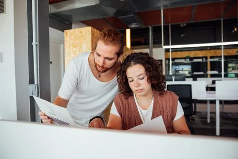 Focused colleagues working with documents in office Stock Photos