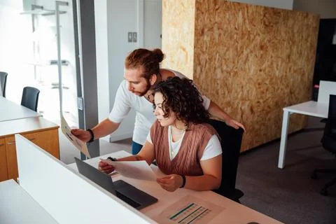 Focused colleagues working with documents in office Stock Photos