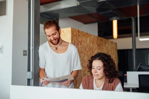 Focused colleagues working with documents in office Stock Photos