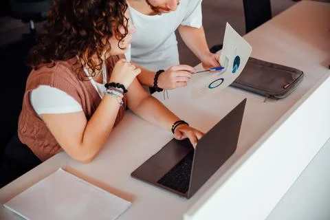 Focused colleagues working with documents in office Stock Photos