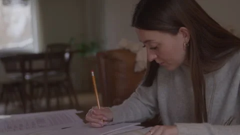 Focused College Student Writes In Notebook With Pencil Stock Footage 270330594