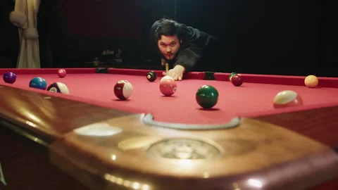 Focused competitor lines up difficult long shot on red table 스톡 동영상 329192798