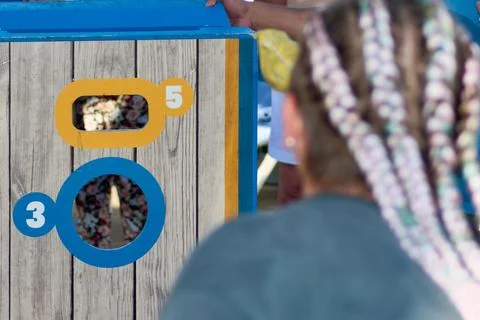 Focused competitor throwing at cornhole board Stock Photos