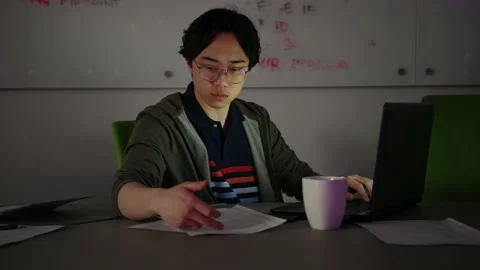 Focused computer programmer working late at laptop in conference room Stock Footage 220346227