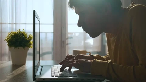 Focused concentrated young man typing on keyboard while working on laptop Stock-Footage 255832392
