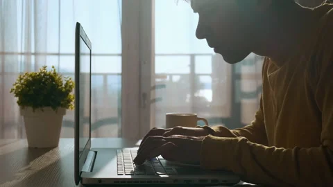 Focused concentrated young man typing on keyboard while working on laptop Stock Footage 279645770