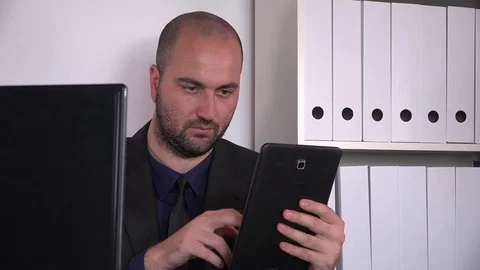 Focused confident executive working indoor slide tapping tablet computer closeup Stock Footage