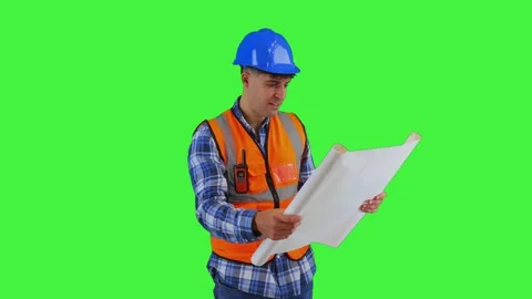 Focused construction engineer reviewing project blueprints wearing orange v.. Stock Footage 286985784