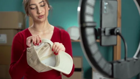 Focused content creator filming a craft tutorial with smartphone and ring light. Stockbeeldmateriaal 276107205