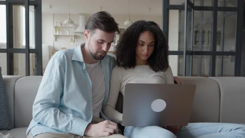 Focused Couple Browsing Laptop Together, Discussing Something Serious at Home 스톡 동영상 303086235