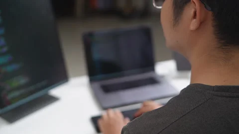 Focused Developer Coding on Laptop in a Remote Work Environment Stock Footage 336679807
