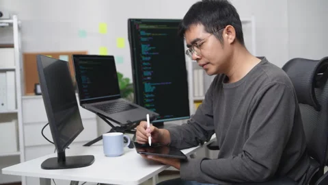 Focused Developer Programming on Multiple Screens in a Professional Home Of.. Stock Footage 336680302