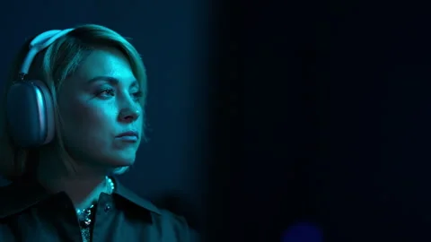 Focused developer on typing complex code in neon lit home office, listening Stock Footage 274652112