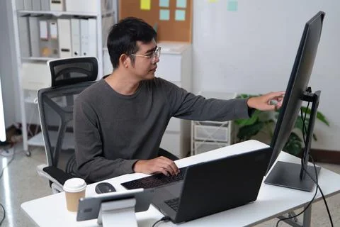 Focused Developer Working on a Computer in a Professional Office Environment Stock Photos