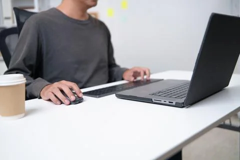 Focused Developer Working on Laptop with Wireless Keyboard and Mouse in Offic Stock Photos