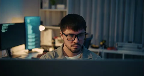 Focused Developer Working Late at Night in Tech Office. 動画素材 306738560