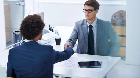 Focused on developing solid partnerships. a serious businessman shaking hands Fotos Stock