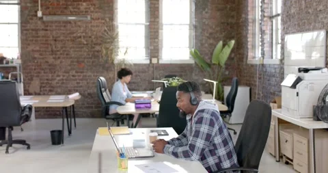 Focused diverse colleagues having video call in office in slow motion Stock Footage 341392911