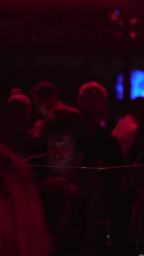 Focused DJ Performing Live Electronic Music Set in Nightclub Crowd Stock Footage 337902553