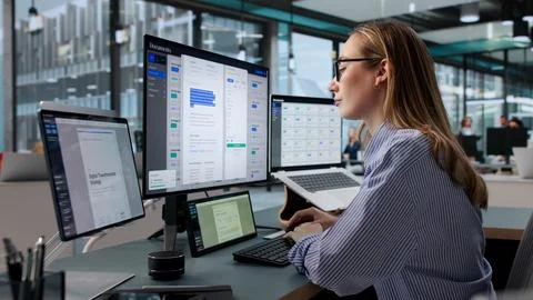 Focused Document Manager Using Laptop To Organize Digital Files Efficiently. Stock Photos