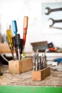Focused drills with screwdrivers in background Stock Photos