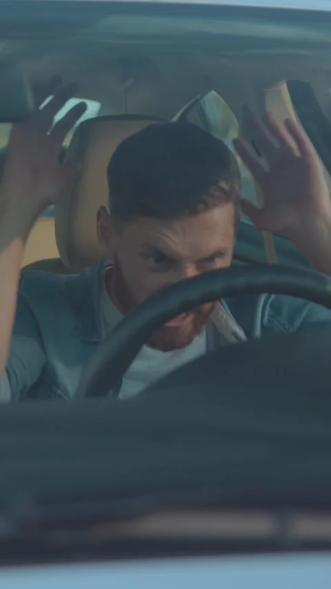 A focused driver skillfully navigating a modern vehicle along an open road Stock Footage 303780322