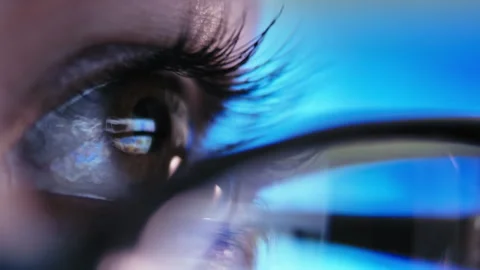 Focused Efficiency: Detailed Close-Up of Womans Glasses Showing Laptop Work Stock Footage 293258498