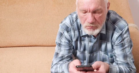 Focused elderly man holding mobile learning digital technology surfing internet Stock Footage 147049577