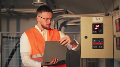 Focused Engineer Looks Concerned While Using Laptop in Technical Room Stock-Footage 321733898