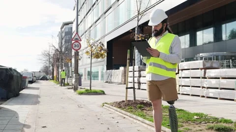 Focused Engineer with Prosthetic Limb Inspecting Urban Building Site Stock Footage 264035230