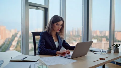 Focused executive typing laptop by modern office panoramic window closeup. Stock Footage 319954752
