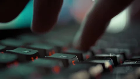 In a focused extreme close-up a programmers agile fingers swiftly press keyb Video stock 331475179