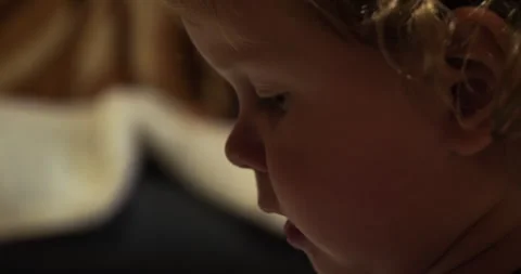 A focused face in a three year old boy. The toddler's face in profile is tense Stock Footage 274880904